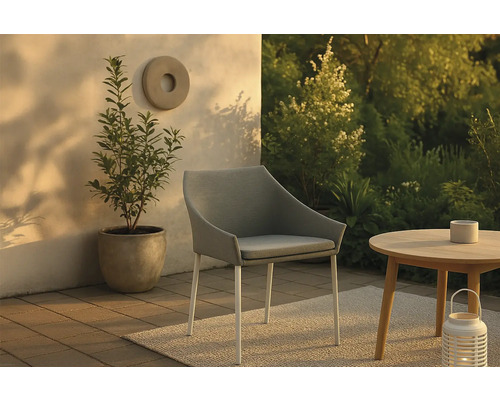 Scen med stoppad stol, sidobord och krukväxt för utomhusbruk