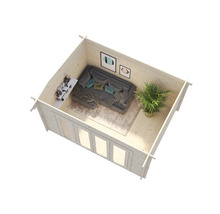 Interiörbild av ett trädgårdshus i trä med soffa, hylla, krukväxt och tavlor på väggen