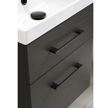 Detaljvy av ett tvättställsskåp med två lådor och ett handfat ovanpå