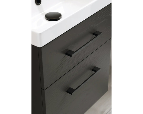 Detaljvy av ett tvättställsskåp med två lådor och ett handfat ovanpå