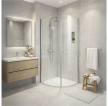 Ljust badrum med duschkabin, tvättställ och spegel med belysning.