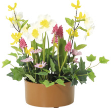 Blomsterarrangemang med olika konstgjorda blommor i en kruka