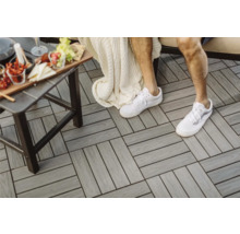 Kompositplattor på en terrass med bord och person