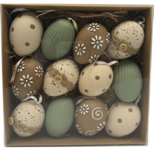 Set med tolv påskägg i olika mönster som prickar, blommor och ränder i en ask med halm.