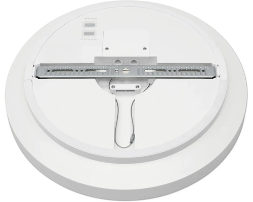 Baksida av en rund taklampa med monteringsfäste i metall och kopplingsdosa.