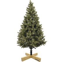 Konstgjord julgran med gröna barr på en julgransfot av trä från Krinner.
