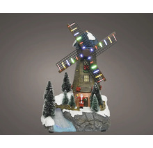 Juldekoration väderkvarn med LED-belysning, jultomte och snöiga granar på klippig bas