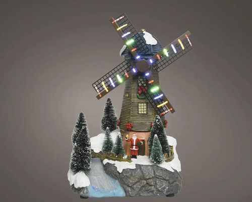 Juldekoration väderkvarn med LED-belysning, jultomte och snöiga granar på klippig bas