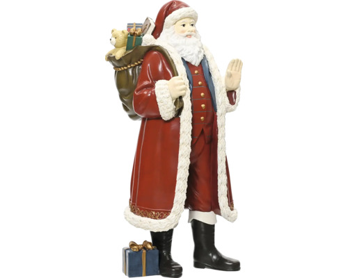 Jultomtefigur med en säck full av presenter på ryggen och ett paket vid fötterna, traditionell juldekoration.