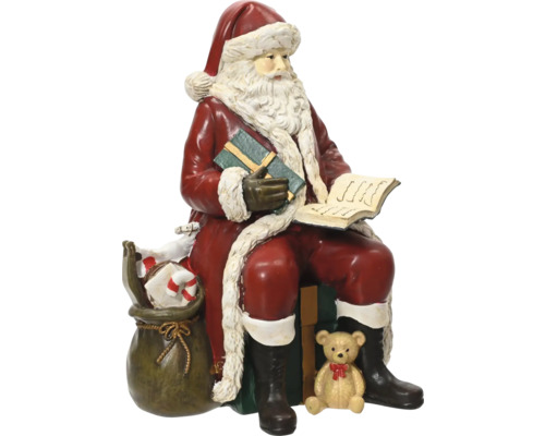 Dekorativ sittande jultomtefigur med ett paket, en bok, en säck med presenter och en nallebjörn.