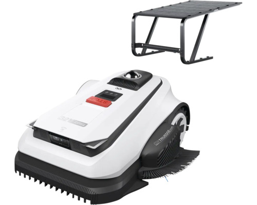 Robotgräsklippare med vitt hölje, svarta detaljer och röd stoppknapp, inklusive ett svart garagetak.