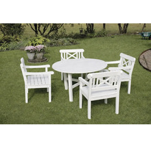 Vit trädgårdsgrupp med ett runt träbord och fyra karmstolar med kryssrygg på en gräsmatta.