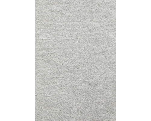 Närbild av en mjuk, strukturerad grå mattyta av textilfibrer.