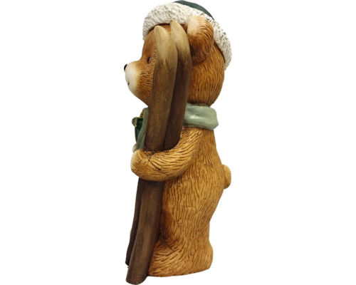 Dekorationsfigur björn med skidor, vintermössa och halsduk.
