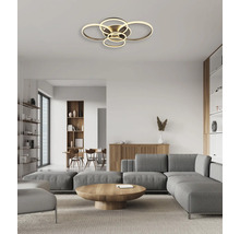 Modern LED-taklampa med flera ringar i ett ljust, organiserat vardagsrum med grå soffa och trämöbler.