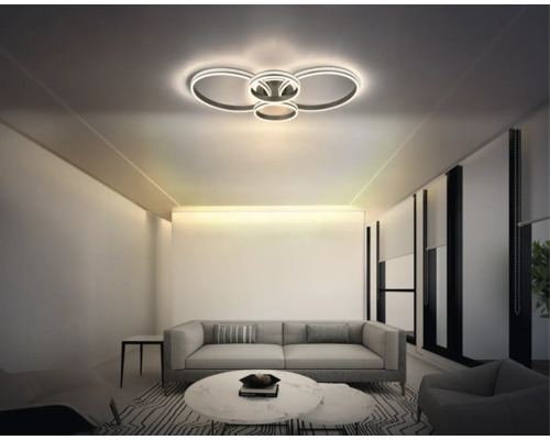 Modern LED-taklampa i ringdesign i ett ljust vardagsrum med grå soffa och marmorbord.