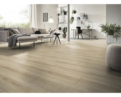 Ljust och rymligt vardagsrum med laminatgolv i trälook, modern soffa, arbetsplats och dekorativa krukväxter.