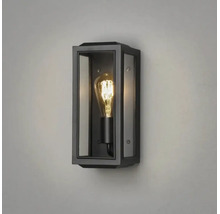 Rektangulär utomhusvägglampa med svart metallram, glaspaneler och lysande filamentglödlampa.