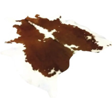 Matta av naturligt koskinn med brunvitt fläckigt mönster.