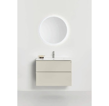 Modernt tvättställsskåp med två lådor, tvättställ, blandare och upplyst rund väggspegel för ett minimalistiskt badrum.
