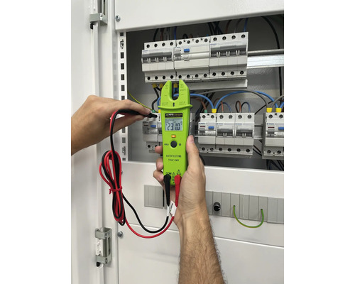 Elektriker mäter spänning i en elcentral med en KPS strömmätare