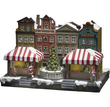 Julmarknadsscen med upplysta hus och figurer
