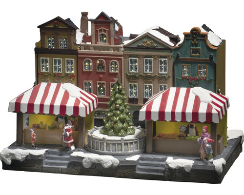 Julmarknadsscen med upplysta hus och figurer