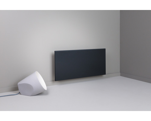 Hörn av rum med panelvärmare och lampa