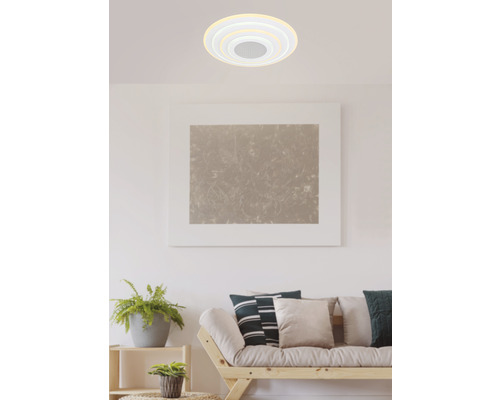 Miljöbild med en vit taklampa i vardagsrummet.