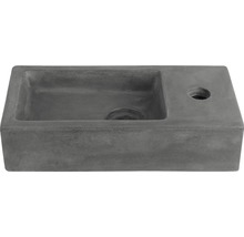 Grått tvättställ i betong med kranhål