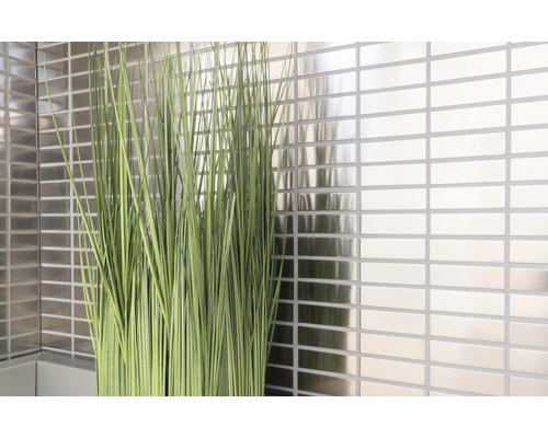 Väggdekoration med rektangulära, glänsande plattor och prydnadsgräs