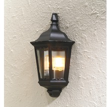 Svart vägglampa med glödlampa monterad på en vägg.