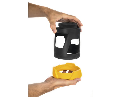 Två produktdelar hålls av händer. Svart hölje ovanför gul tillbehör.