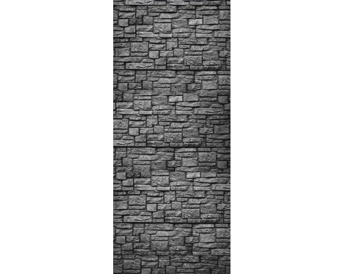 Stenvägg med oregelbundet mönster av naturstenar