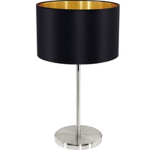 Bordslampa med rund, svart lampskärm och metallfot