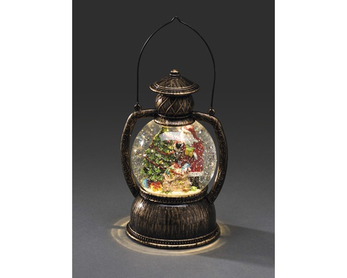 Snöglob med jultomte och julgran i lykta