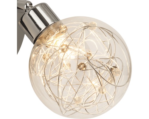 Klotformad vägglampa med trådnät och dekorativa stenar