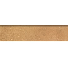 Närbild av en golvplatta med en sandfärgad yta