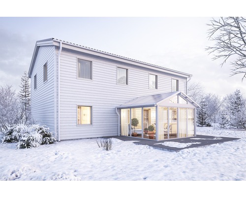 Vinterlandskap med hus och tillbyggnad