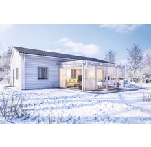 Trähus med glasutbyggnad på vintern