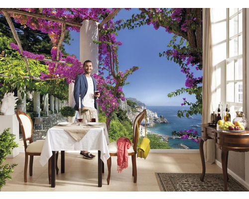 Fototapet med man på terrass med havsutsikt