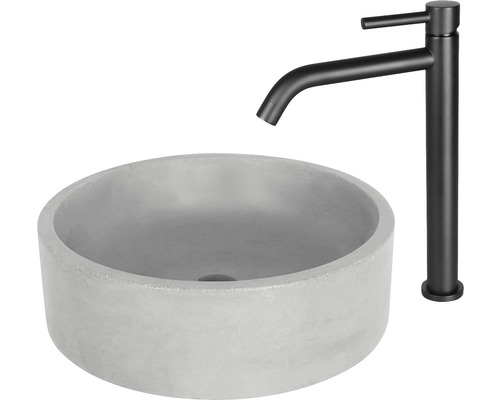 Runt tvättställ i betong med svart vattenkran