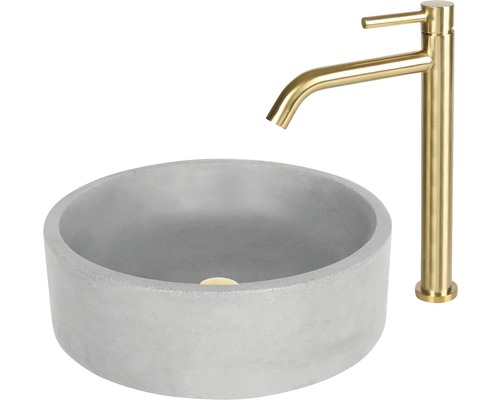 Rund tvättställsskål i betong med guldfärgad blandare
