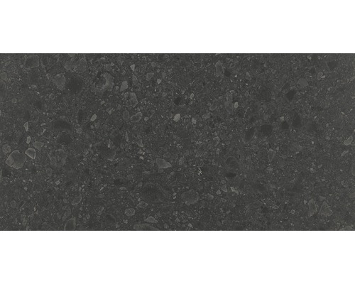 Mörk keramikplatta med spräcklig yta