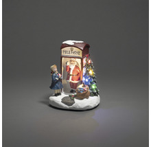 Dekorativ julscen med telefonkiosk, jultomte och flickfigur