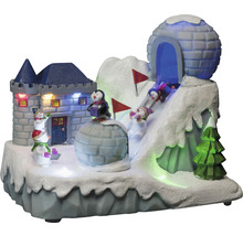 Dekorativt vinterlandskap med slott, igloo, pingviner, snögubbar och skidåkare