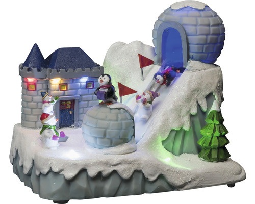 Dekorativt vinterlandskap med slott, igloo, pingviner, snögubbar och skidåkare