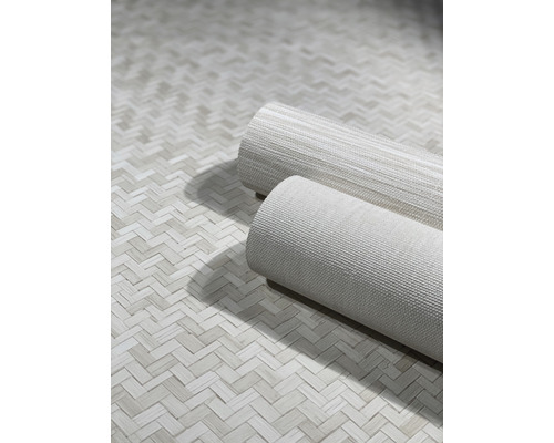 Två rullar tapeter på en yta med fiskbensmönster