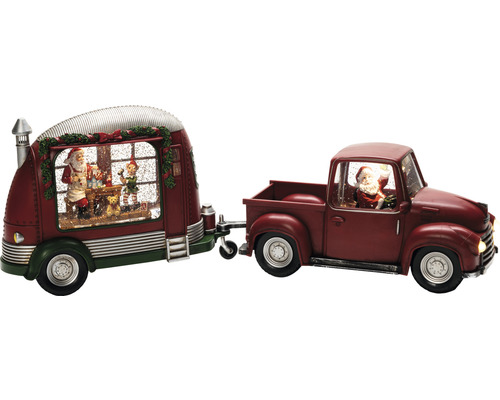 Juldekoration med snöglob, jultomte i lastbil och husvagn med figurer