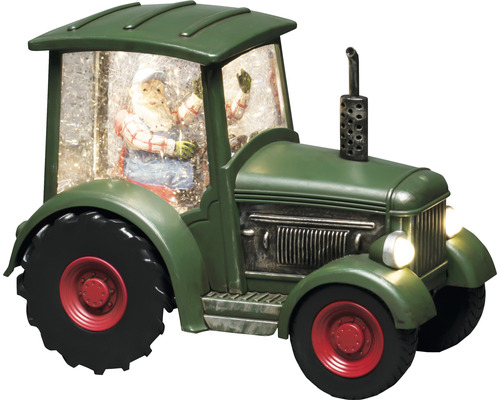 Dekorativ grön traktor med jultomtefigur och snö